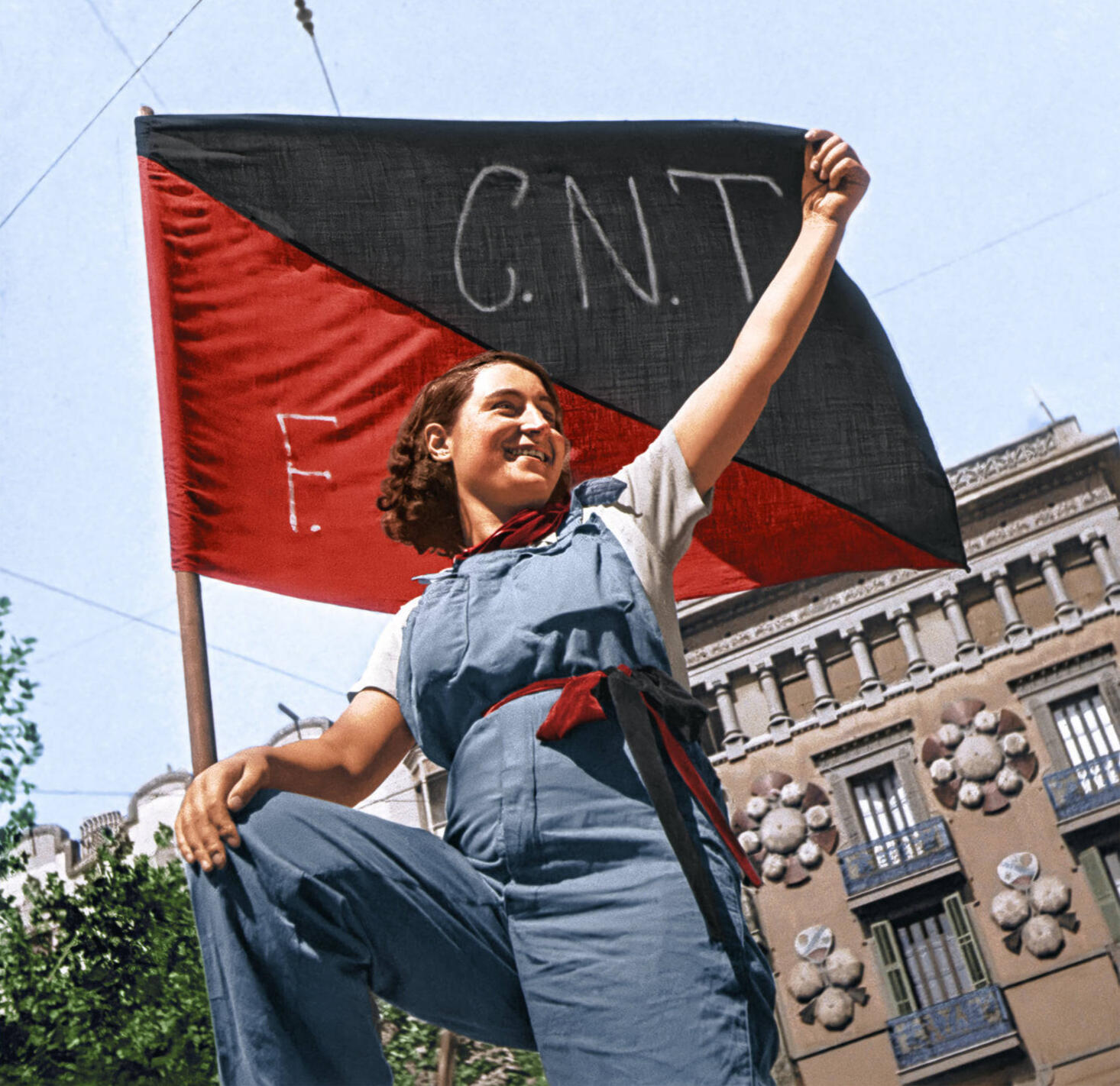 Famous colorized image of anarchist militiawoman Anita Garbín holding up a flag of the CNT-FAI.